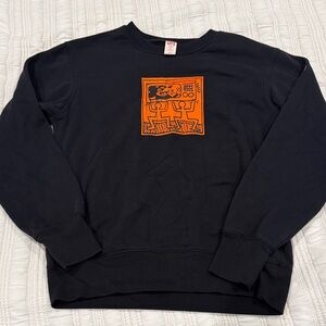 Disney Black Crewneck Sweater with Bold Orange Design